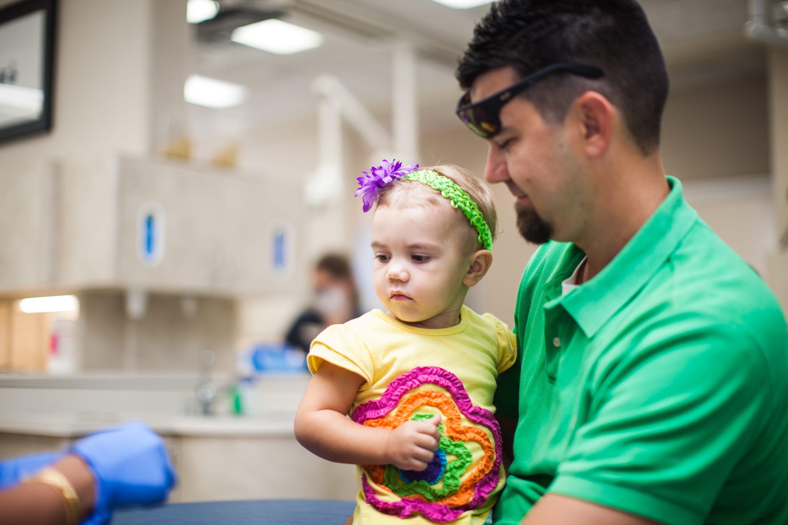 Young child being held during a friendly pediatric dental visit