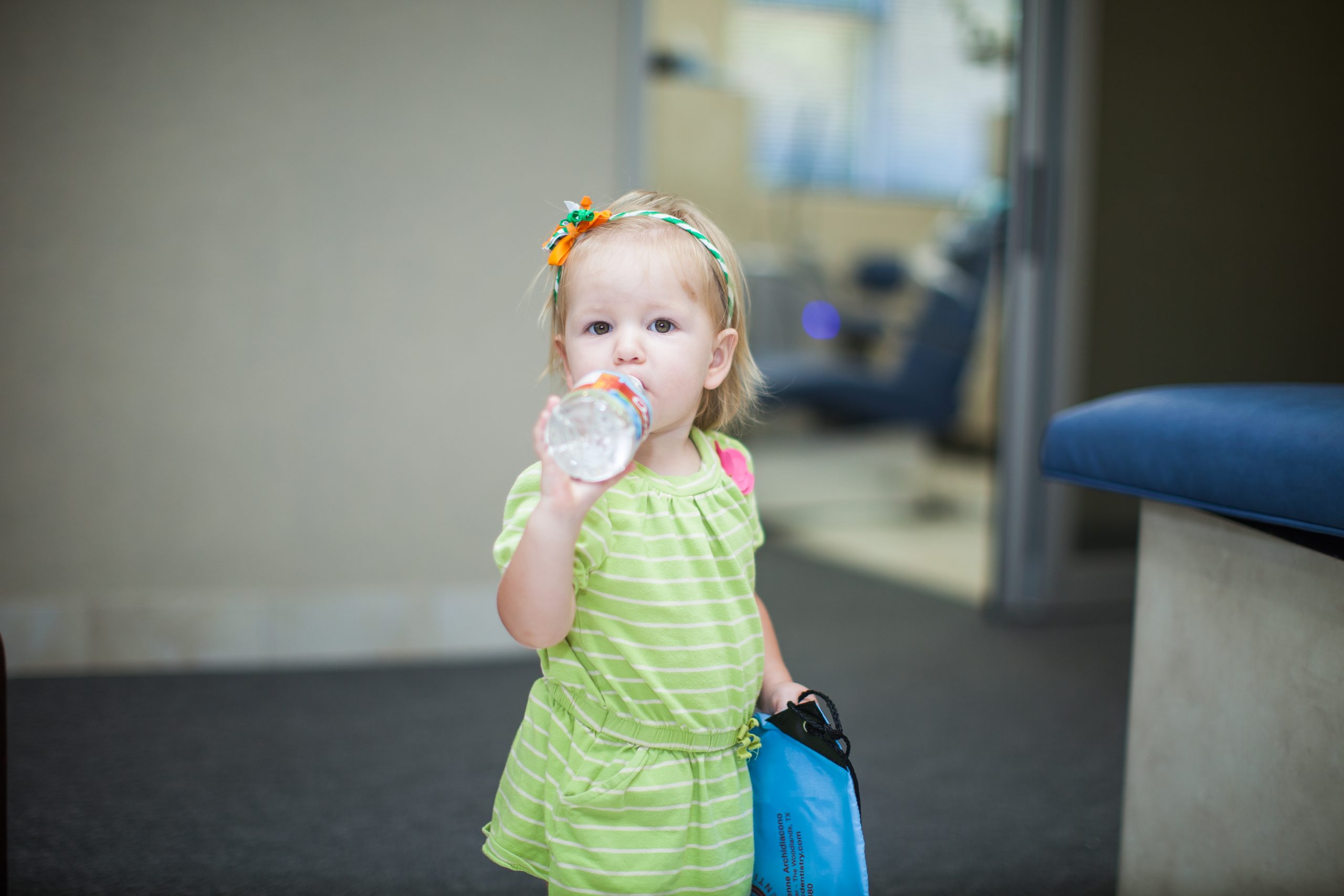 Young child being held during a friendly pediatric dental visit